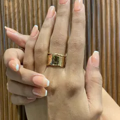 A close-up of the finished look against a textured background. Notice the clean lines and the healthy, glossy shine of the gel extensions.