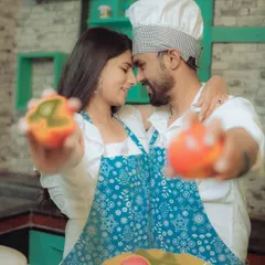 Love is cooking up something beautiful! This couple shares a laugh in a quirky kitchen setting, a perfect example of a themed pre-wedding shoot that reflects shared interests and creates fun, natural interactions.