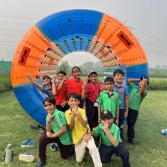 A group of happy campers poses with the Zorbing Roller. Activities like these are not just fun but also promote cooperation and create lasting bonds among students.