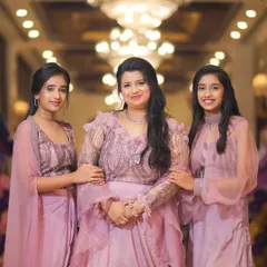 A beautiful photo of a mother with her daughters at Purvi's 5th birthday party, all dressed in matching lavender outfits.