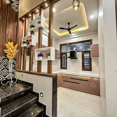 This design showcases a kitchen that opens up to the rest of the home, with a decorative wooden partition that adds style while maintaining an open feel. The layout is perfect for modern, integrated living.