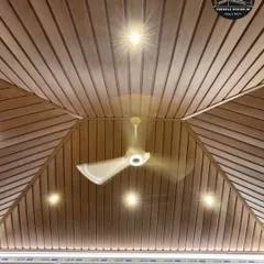 The beauty is in the details. This upward view showcases the flawless finish of a wood-paneled PVC ceiling, complete with recessed lighting and a fan, ensuring comfort and elegance within the glass enclosure.