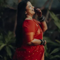 A moment of pure, uninhibited laughter. This candid shot of Neelam in her beautiful red saree shows the joy that love brings.