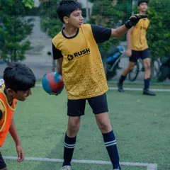 A young goalkeeper directs his teammates during a training game.