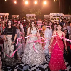 Your tribe should always match your vibe. This is a beautiful shot of the bride entering with her bridesmaids, using pink ribbons to create a unique and connected entry moment.