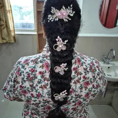 A lovely fishtail messy braid decorated with delicate floral pins. This hairstyle is a great choice for a soft, bohemian-inspired look for any wedding function.