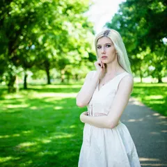 An outdoor fashion portrait from a shoot in London. Using the natural frame of the trees and a wide perspective, this shot establishes a serene and classic mood, highlighting the model's presence in the environment.