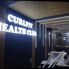 I also specialize in commercial interiors, like this project for Curlfit Health Club. I used a combination of dark WPC louvers for the walls and lighter wooden-finish panels for the ceiling to create a modern and energetic vibe. The backlit 3D signage adds a professional finishing touch.