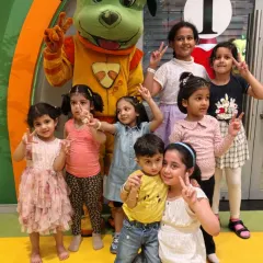 A group of friends pose with our mascot, Tinga Dojo. We love capturing these moments of pure joy and friendship.