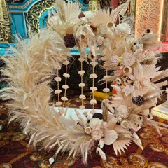 Another example of my boho decor, this circular wreath is made with fluffy pampas grass and other dried botanicals. The hanging tassels in the center add a touch of delicate detail to this rustic piece.