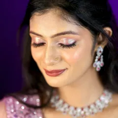 A close-up of a glamorous reception look. The focus is on the sparkling silver eyeshadow and the flawless, glowing skin.
