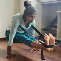 Our TTC students practice Brahmacharyasana, an arm balance, using straps to support the legs. This modification helps build the required arm and core strength while maintaining the integrity of the pose.