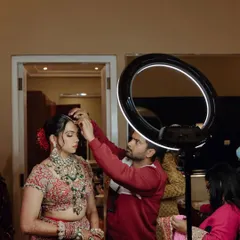 A behind-the-scenes shot of the makeup artist putting the final touches on bride Nikita. It takes a team to create the perfect bridal look, and I work closely with them all.