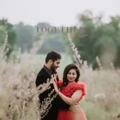 A soft, dreamy portrait of the couple in a field of wildflowers. The focus is on their gentle interaction, creating a timeless and romantic image.