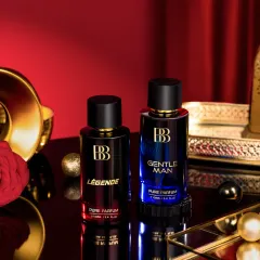 A close-up shot of two perfume bottles styled with luxurious props like a golden tray and a fabric rose. The lighting is carefully controlled to make the glass shine while minimizing harsh reflections, a process that requires extensive cleanup in post-production.