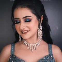 A close-up of the engagement bride's stunning makeup. The bold blue smokey eye is the star of the show, balanced by a flawless base and a soft lip color.