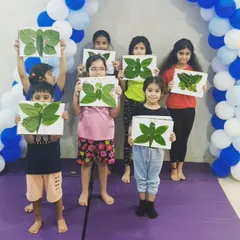 Kids displaying their beautiful butterfly art made from natural leaves. We offer themed craft workshops that are both fun and educational.