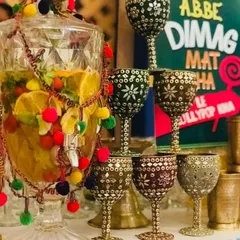 It's all about the details in my Funjabi theme. I use ornate, mirror-work goblets and a large drink dispenser decorated with colorful pom-poms to serve refreshing drinks with a traditional twist.