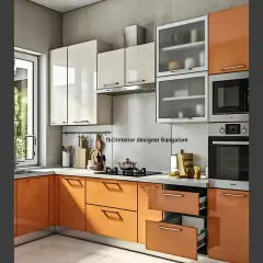 This L-shaped kitchen makes a statement with vibrant orange cabinets. Paired with glossy white upper cabinets and frosted glass, the design is energetic and functional, featuring deep drawers for easy storage.