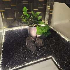 Don't forget the small, unused corners in your home. I created this modern indoor pebble landscape with artificial plants and integrated lighting to transform the empty space under a staircase into a stylish feature.