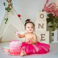 This boho-chic cakesmash setup features a beautiful pink ombre cake and a rustic teepee. It's a perfect example of how I tailor themes to create a stylish and memorable first birthday photoshoot.