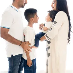 A beautiful profile shot of the family interacting. This candid style of photography captures the natural connections and love between family members.