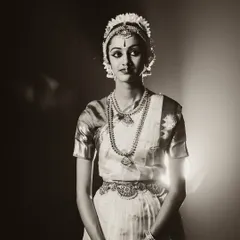 Another beautiful pose from a classical dance session. The lighting isolates the dancer, focusing on the intricate hand gestures and expressive eyes that are central to Indian classical dance.