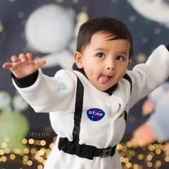 A cheeky astronaut reporting for duty. This little one's playful expression is out of this world! Themed shoots are a great way to capture your child's imagination.