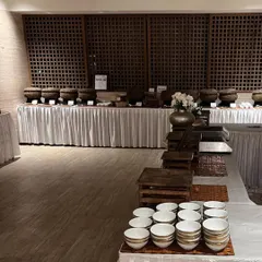 Another angle of a grand buffet, showcasing the extensive layout and the variety of dishes offered in our rustic-themed serveware.