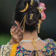 Another angle of the messy khopa, showing how the accessories are placed to create a balanced and beautiful design from all sides.