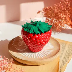 The classic red Strawberry Jar, hand-painted with a high-gloss finish. It's the perfect size for jewelry, keepsakes, and other small trinkets.