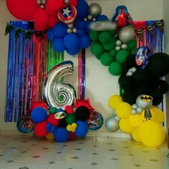 A colorful Avengers-themed birthday decoration for a 6-year-old. I used balloons representing different heroes like Hulk, Captain America, and Batman, with a silver fringe curtain for the photo backdrop.