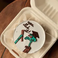A fun graduation or achievement cake featuring Squidward from Spongebob Squarepants, with the message "you did it!". It's a quirky way to say congratulations.