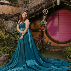 A whimsical shot from the same pre-wedding shoot. The glamorous makeup and hairstyle work beautifully with the dramatic trail of her gown and the unique setting.