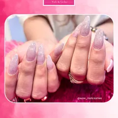 Feel the fantasy with these extra-long, sparkling stiletto extensions. Coated in a shimmering lavender glitter polish, these nails are designed for those who love to make a bold and glamorous statement.