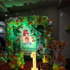 For kids' parties, themes are everything. Here is a jungle theme I did for a first birthday, complete with a personalized backdrop, animal cutouts, a full balloon arch, and a light-up number '1'.