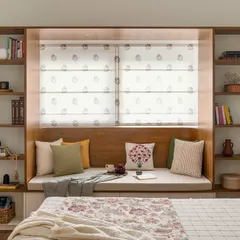 Personal sanctuaries are our specialty. In our 'Palaash' project, we designed this cozy bay window nook flanked by custom bookshelves, creating the perfect, sunlit corner for quiet reading and relaxation within the master bedroom.