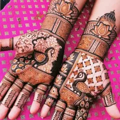 A beautiful combination of peacock and lotus motifs. The use of negative space makes the peacock design on the palm stand out.