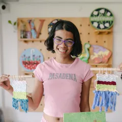 This happy camper is proudly showing off the beautiful tapestries she made during our weaving session. Our art camps are all about exploring new materials and discovering the joy of making things by hand.