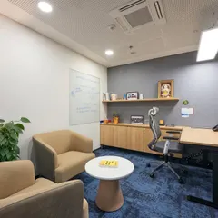 This executive cabin is designed to be both a private workspace and a small meeting area. It features an ergonomic chair, an adjustable-height desk, and comfortable visitor chairs, all within a compact and well-lit room.