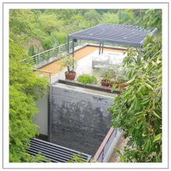 A tranquil rooftop retreat in Alibaug. We designed this terrace with a modern pergola and a slate water feature, creating a peaceful space to enjoy the surrounding forest views.