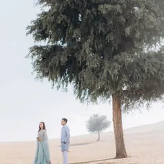 A serene and minimalist shot of Saloni and Kanav in the misty Khimsar dunes. The soft light and sparse landscape create a beautifully artistic and romantic photograph.