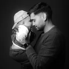 A tender black and white portrait of a father and his baby. These quiet, emotional moments are some of the most precious memories to capture.