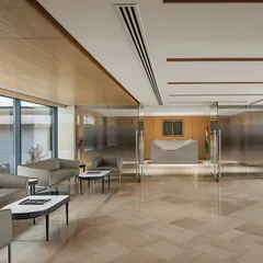 The reception area of 'The Layered Office' in New Delhi. This project involved a complete renovation of the 90,000 sq. ft. headquarters, including restoring the Dholpur stone facade and redesigning all interior spaces.