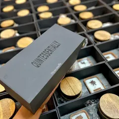 This is a custom corporate gift box we designed for a client, featuring their brand name "Quintessentially" on the lid. We manage the entire process, from sourcing the box to filling it with our handcrafted products, ensuring a professional and high-quality result.