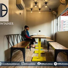 We maximize natural light in our designs to foster a warm and revitalizing environment. This space in 'Cafe Infinity' is perfect for work or casual meetings, featuring custom-built furniture.