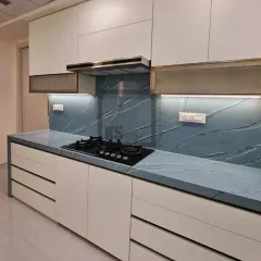 Your kitchen should reflect your personality. For this project, we used a bold blue marble-effect quartz for the countertop and backsplash, creating a stunning statement piece. Paired with clean white cabinetry, it proves that practical kitchens can also be incredibly stylish.