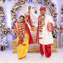 A wide shot of the wedding stage, adorned with flowers and smoke effects, setting a magical scene for the couple's entrance.