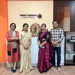 The examining team and I, pictured in front of the Nataraja statue at our academy. This represents our commitment to upholding the traditions and integrity of Indian classical arts.