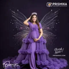 For the mother who dreams of a fairytale, we bring your vision to life. This portrait features one of our elegant, ruffled maternity gowns in a rich purple, complete with a crown and ethereal wings for a truly regal and magical look.